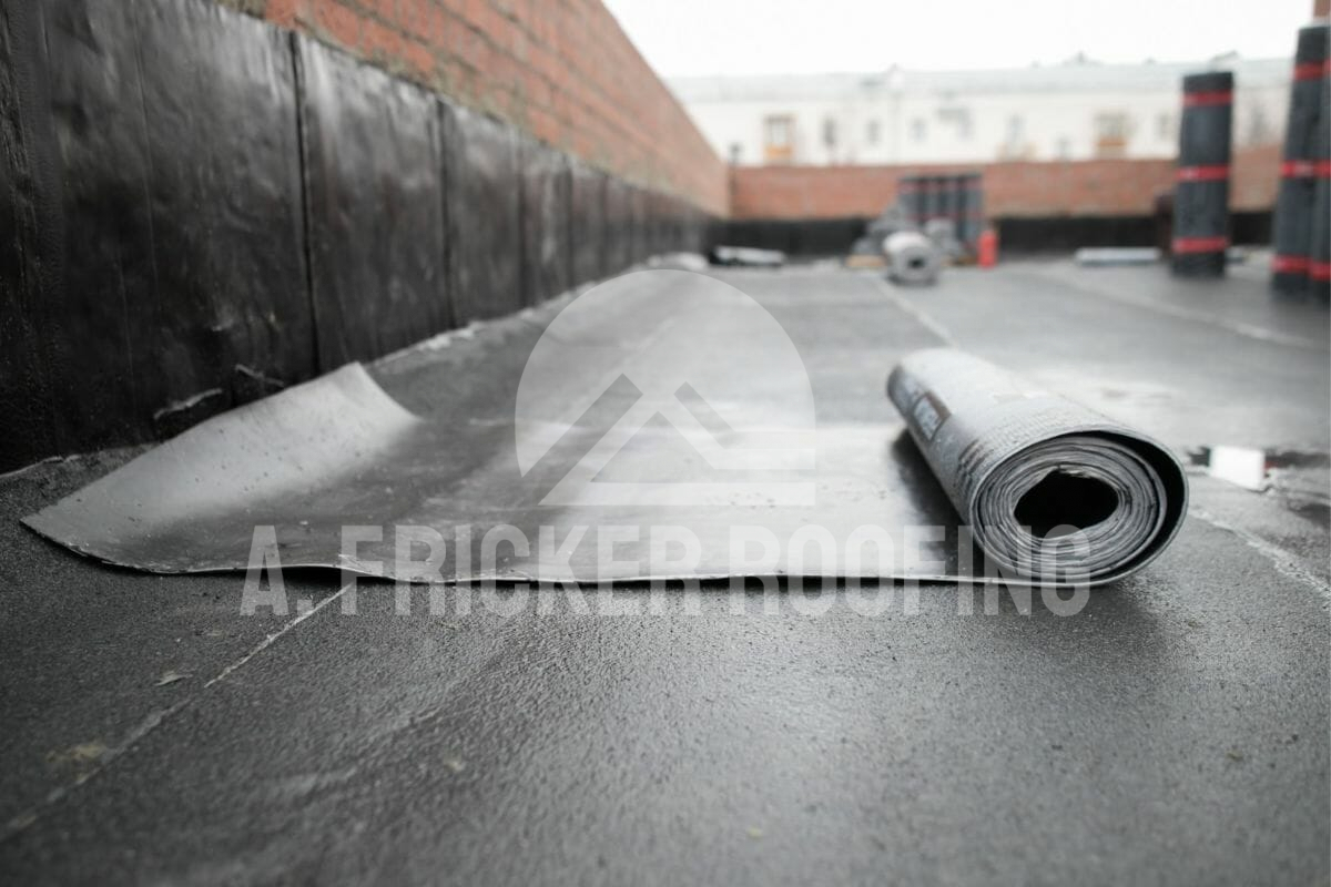 Roll of roofing membrane material on commercial building roof construction site