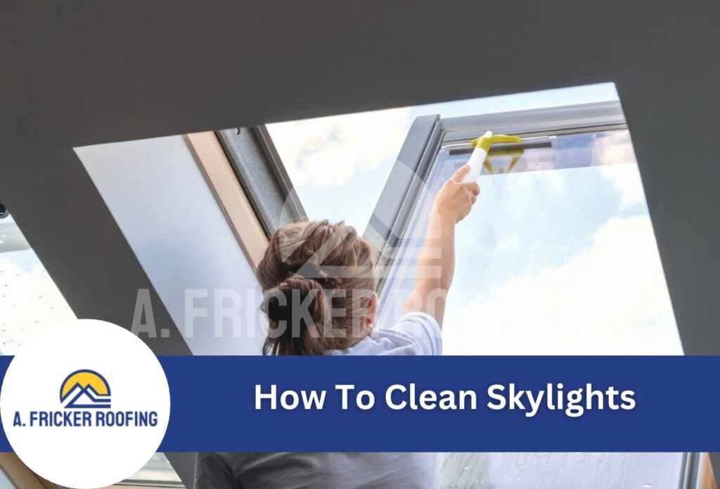 Person cleaning skylight window with squeegee tool from inside home