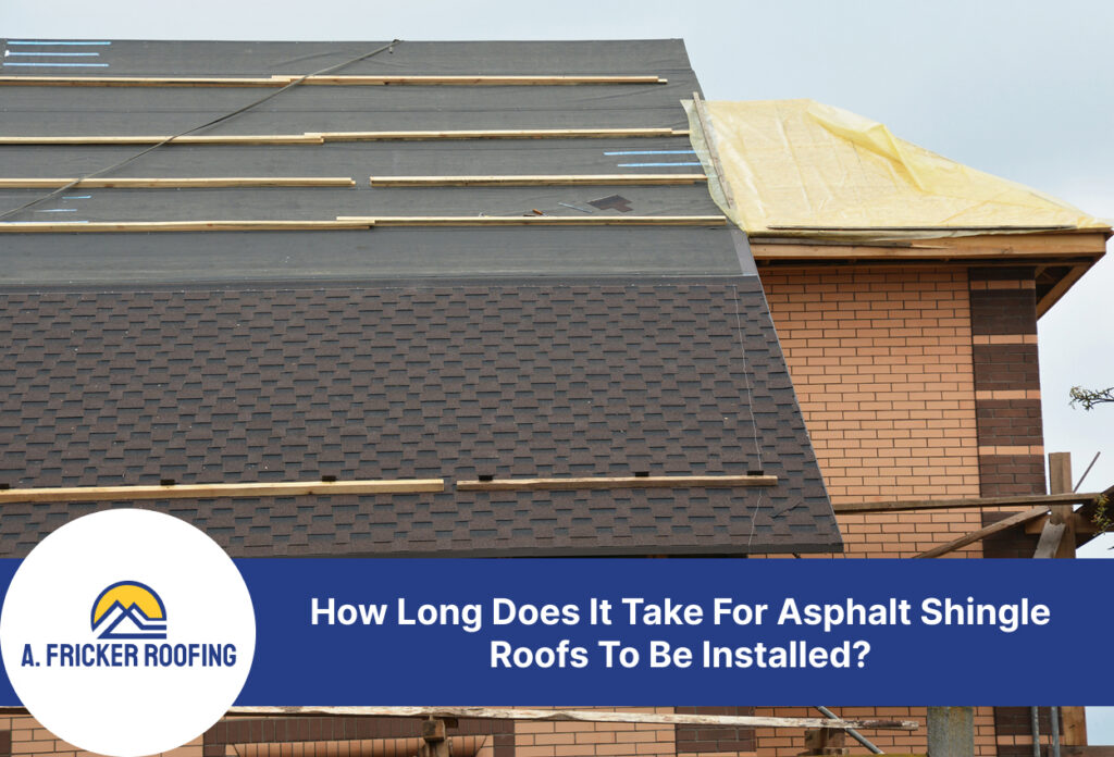 Partial installation of asphalt shingle roofing on a brick house under construction.