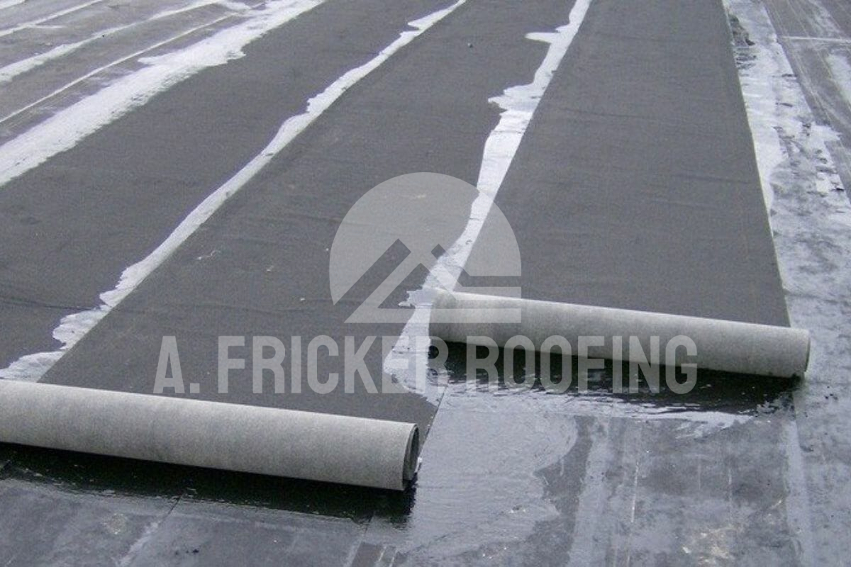 A flat roof with rolled roofing materials by A. Fricker Roofing.