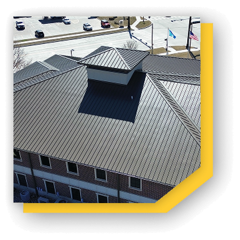 Aerial view of a building with a modern metal roof design.