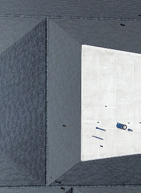 Aerial view of industrial rooftop with a large skylight and maintenance equipment.