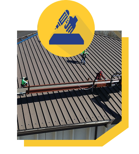 Workers installing a metal roof on a building, emphasizing construction process.